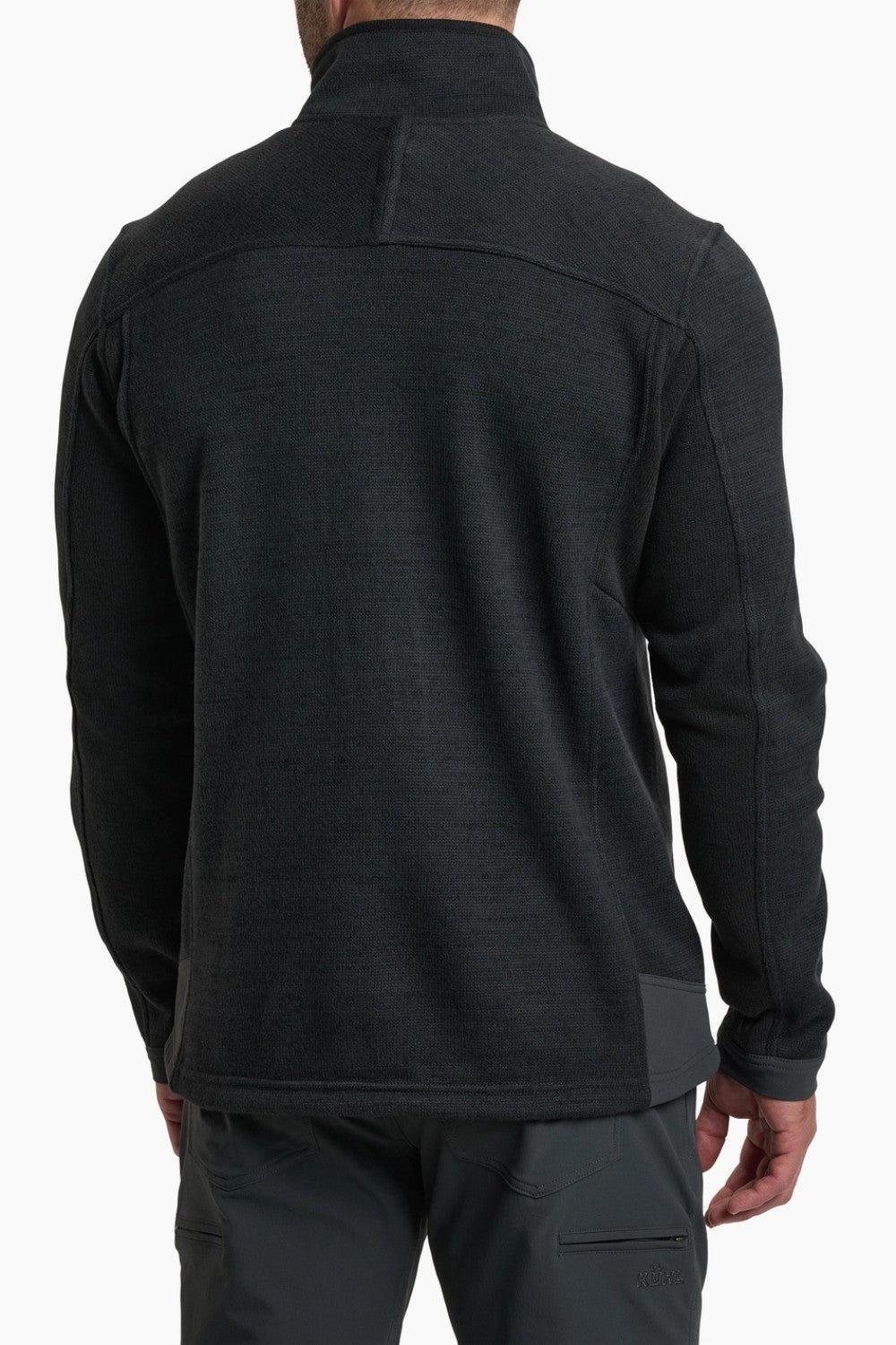 Black long-sleeve jacket worn by a person on a white background