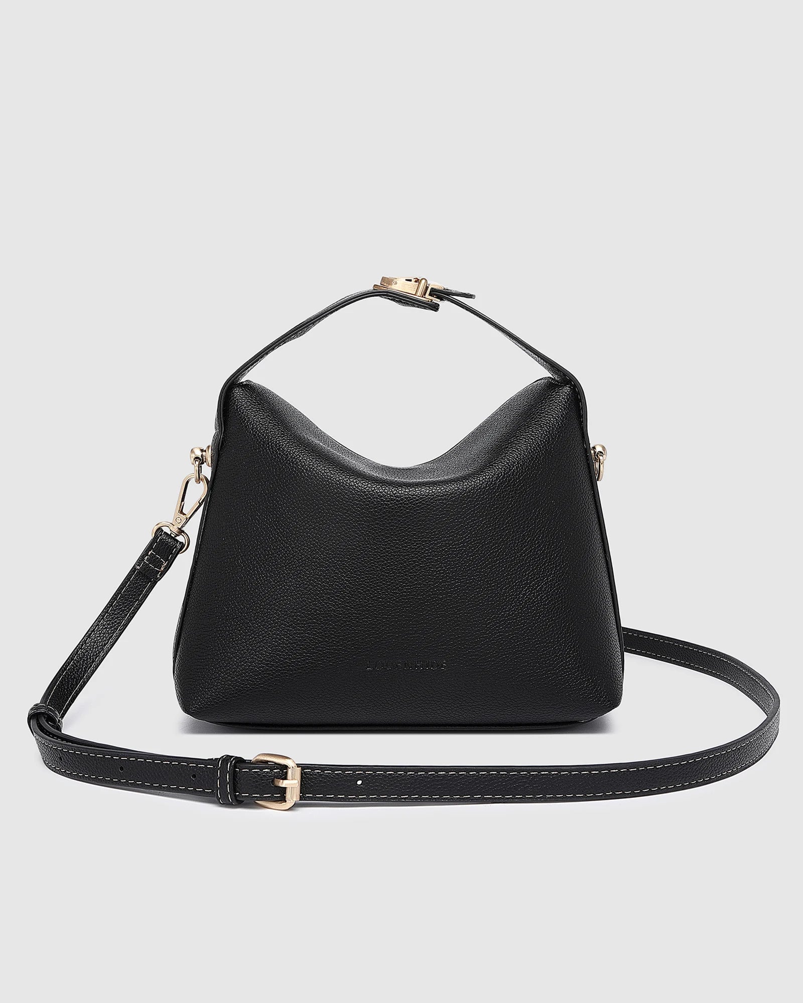 The Louenhide Andie Handbag is this season's go-to event bag. Add an element of playful luxury to your event attire with this sweet and slouchy clutch bag. Designed with a clever minimalistic fold-over closure and two piece clasped handle in a gorgeous trapeze shape, this convertible women's handbag is the perfect way to inject colour into your summer wardrobe. Loop the Andie over your wrist or, for a handsfree moment, attach the adjustable bag strap to wear as a crossbody bag. Showcasing a spacious interio