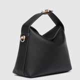The Louenhide Andie Handbag is this season's go-to event bag. Add an element of playful luxury to your event attire with this sweet and slouchy clutch bag. Designed with a clever minimalistic fold-over closure and two piece clasped handle in a gorgeous trapeze shape, this convertible women's handbag is the perfect way to inject colour into your summer wardrobe. Loop the Andie over your wrist or, for a handsfree moment, attach the adjustable bag strap to wear as a crossbody bag. Showcasing a spacious interio