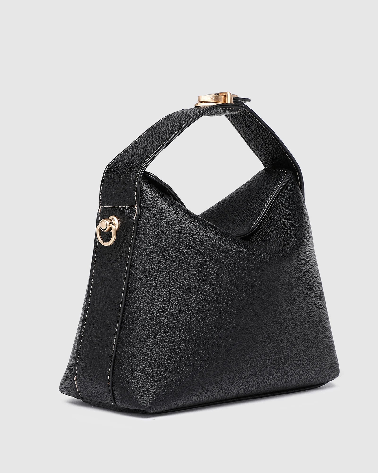 The Louenhide Andie Handbag is this season's go-to event bag. Add an element of playful luxury to your event attire with this sweet and slouchy clutch bag. Designed with a clever minimalistic fold-over closure and two piece clasped handle in a gorgeous trapeze shape, this convertible women's handbag is the perfect way to inject colour into your summer wardrobe. Loop the Andie over your wrist or, for a handsfree moment, attach the adjustable bag strap to wear as a crossbody bag. Showcasing a spacious interio