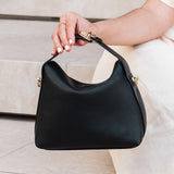 The Louenhide Andie Handbag is this season's go-to event bag. Add an element of playful luxury to your event attire with this sweet and slouchy clutch bag. Designed with a clever minimalistic fold-over closure and two piece clasped handle in a gorgeous trapeze shape, this convertible women's handbag is the perfect way to inject colour into your summer wardrobe. Loop the Andie over your wrist or, for a handsfree moment, attach the adjustable bag strap to wear as a crossbody bag. Showcasing a spacious interio