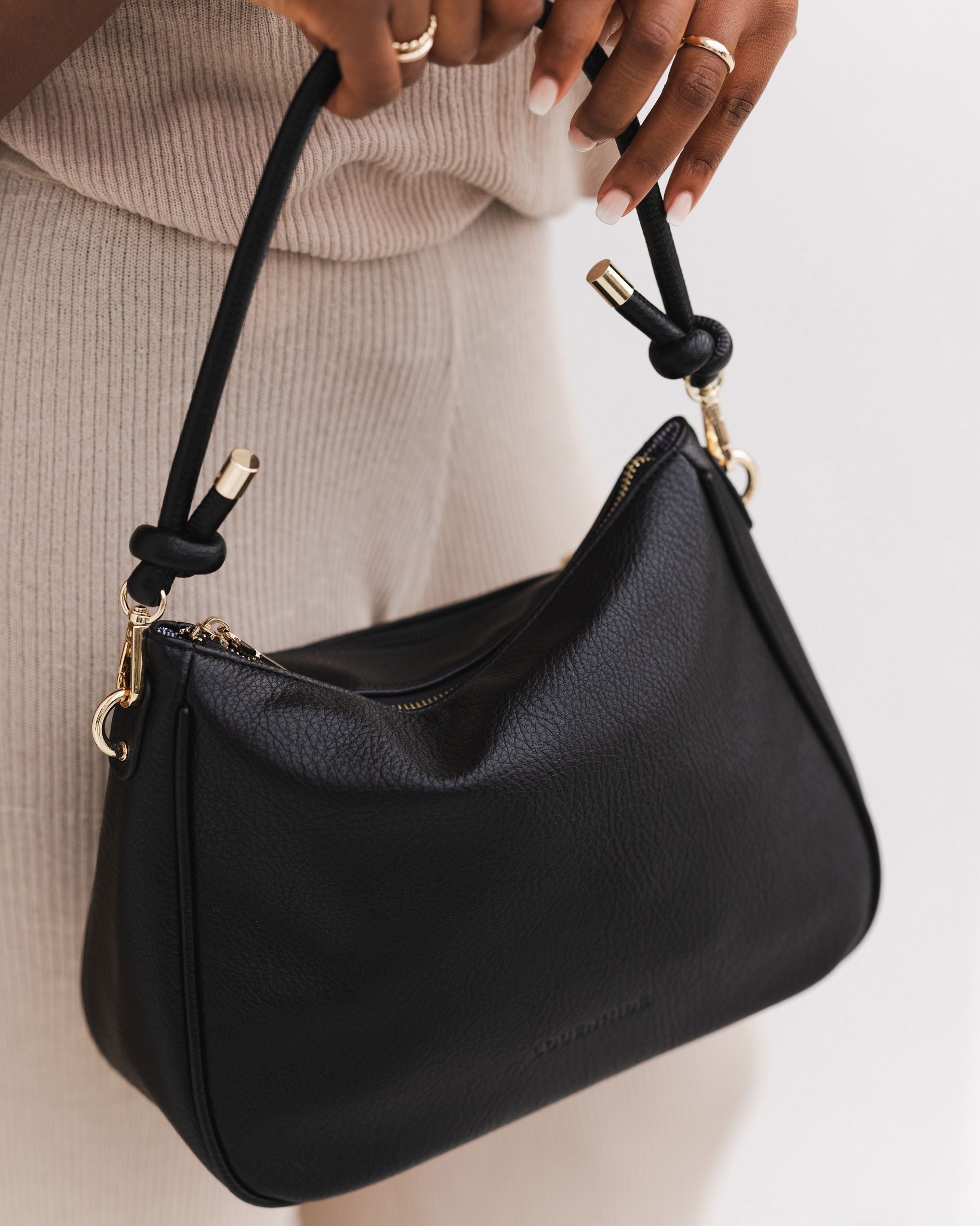 The Louenhide Baby Remi Shoulder Bag is a classic women's everyday bag with elevated style. Designed in a soft and slouchy silhouette with smooth vegan leather, this casual hobo bag is sure to turn heads with its timeless knot detailing strap feature.