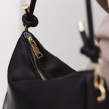 The Louenhide Baby Remi Shoulder Bag is a classic women's everyday bag with elevated style. Designed in a soft and slouchy silhouette with smooth vegan leather, this casual hobo bag is sure to turn heads with its timeless knot detailing strap feature.