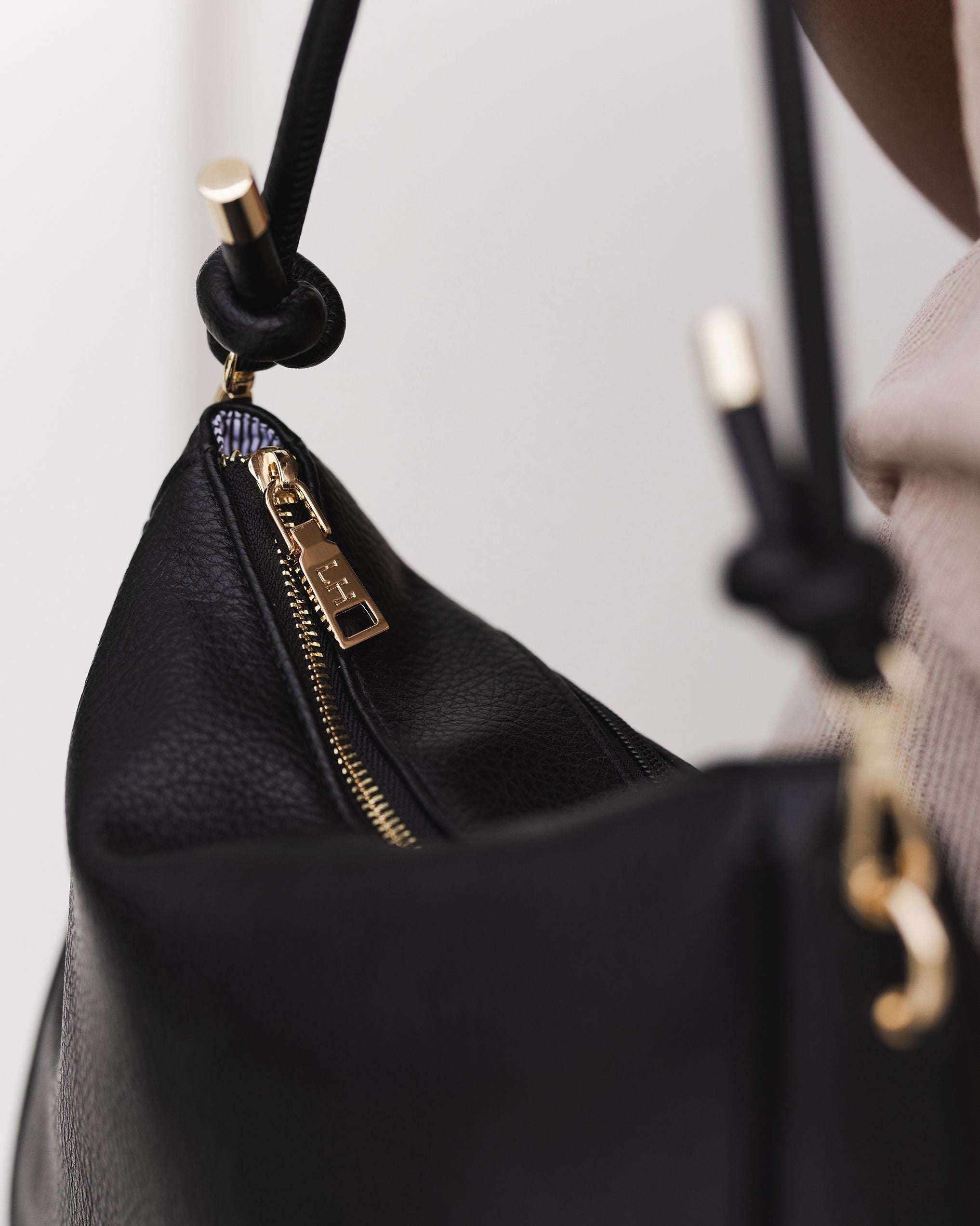 The Louenhide Baby Remi Shoulder Bag is a classic women's everyday bag with elevated style. Designed in a soft and slouchy silhouette with smooth vegan leather, this casual hobo bag is sure to turn heads with its timeless knot detailing strap feature.