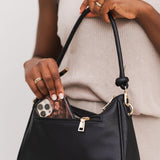 The Louenhide Baby Remi Shoulder Bag is a classic women's everyday bag with elevated style. Designed in a soft and slouchy silhouette with smooth vegan leather, this casual hobo bag is sure to turn heads with its timeless knot detailing strap feature.