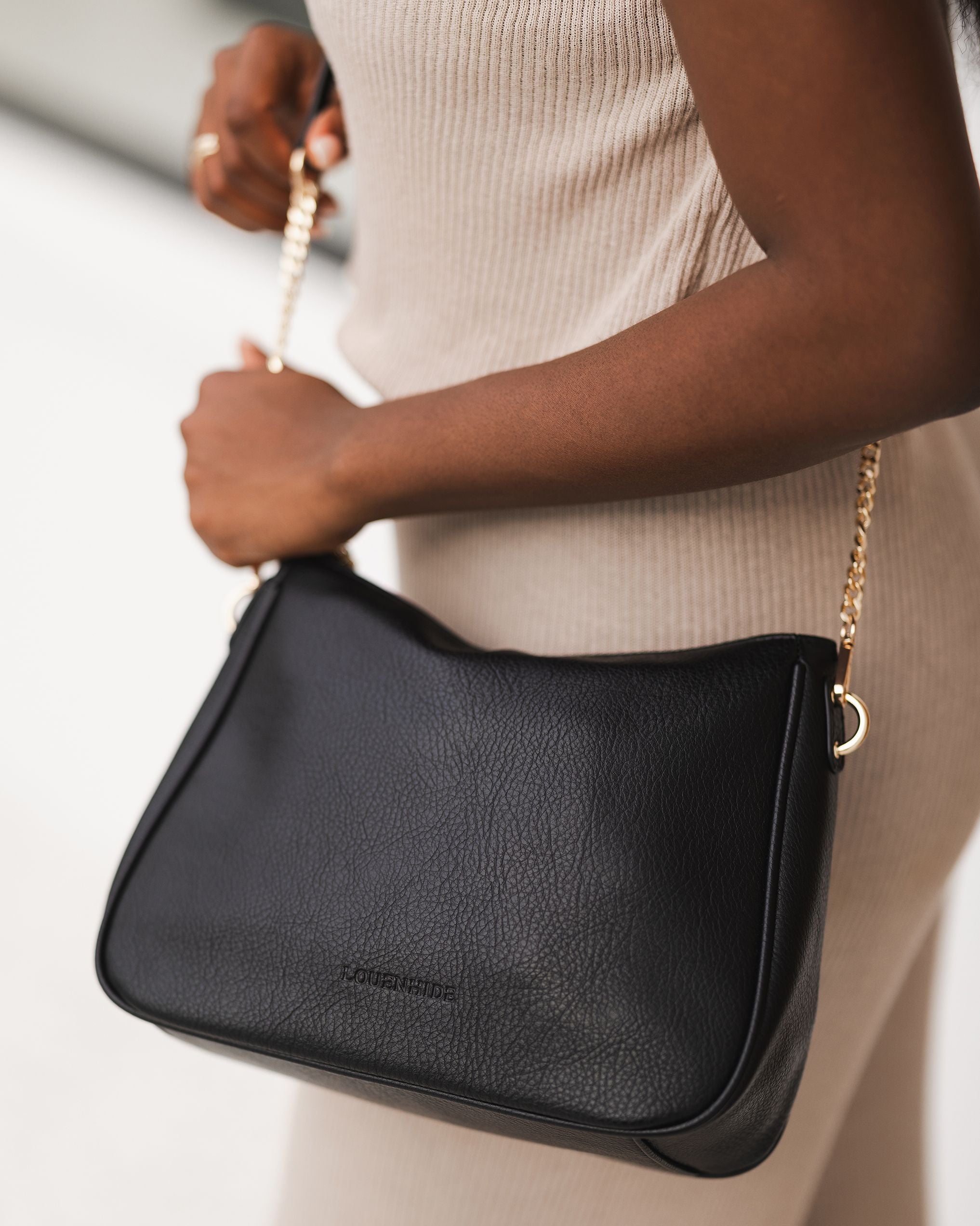 The Louenhide Baby Remi Shoulder Bag is a classic women's everyday bag with elevated style. Designed in a soft and slouchy silhouette with smooth vegan leather, this casual hobo bag is sure to turn heads with its timeless knot detailing strap feature.
