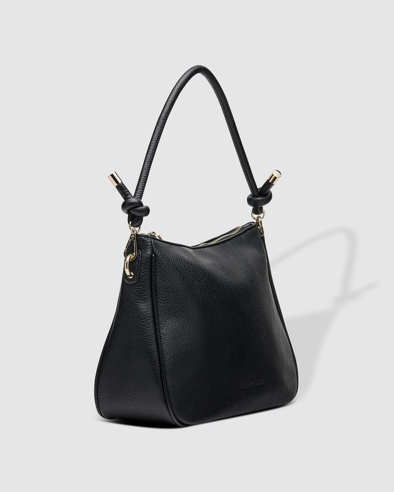 The Louenhide Baby Remi Shoulder Bag is a classic women's everyday bag with elevated style. Designed in a soft and slouchy silhouette with smooth vegan leather, this casual hobo bag is sure to turn heads with its timeless knot detailing strap feature.