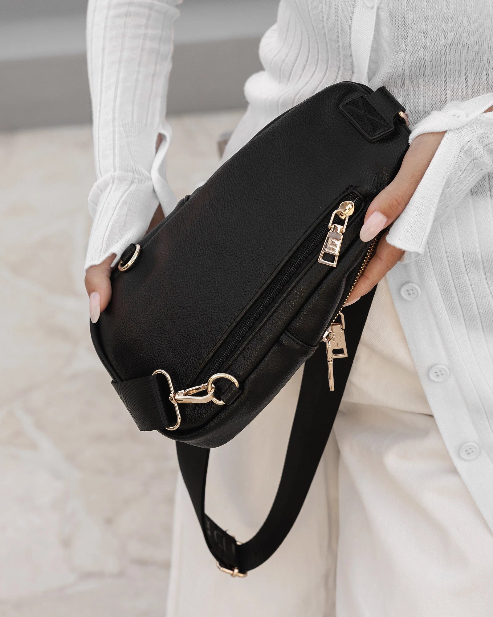 The Louenhide Bella Sling Bag is designed with both style and functionality in mind. Travel organization has never been easier with the dual compartment design ensuring your valuables are within reach and secured safely with the zip closures. Featuring an adjustable and detachable strap allows you to choose the way your bag slings. Whether over your left or right shoulder, this faux leather sling bag ensures comfortable all-day wear. This small sling backpack adds a refined touch to any casual outfit, enhan
