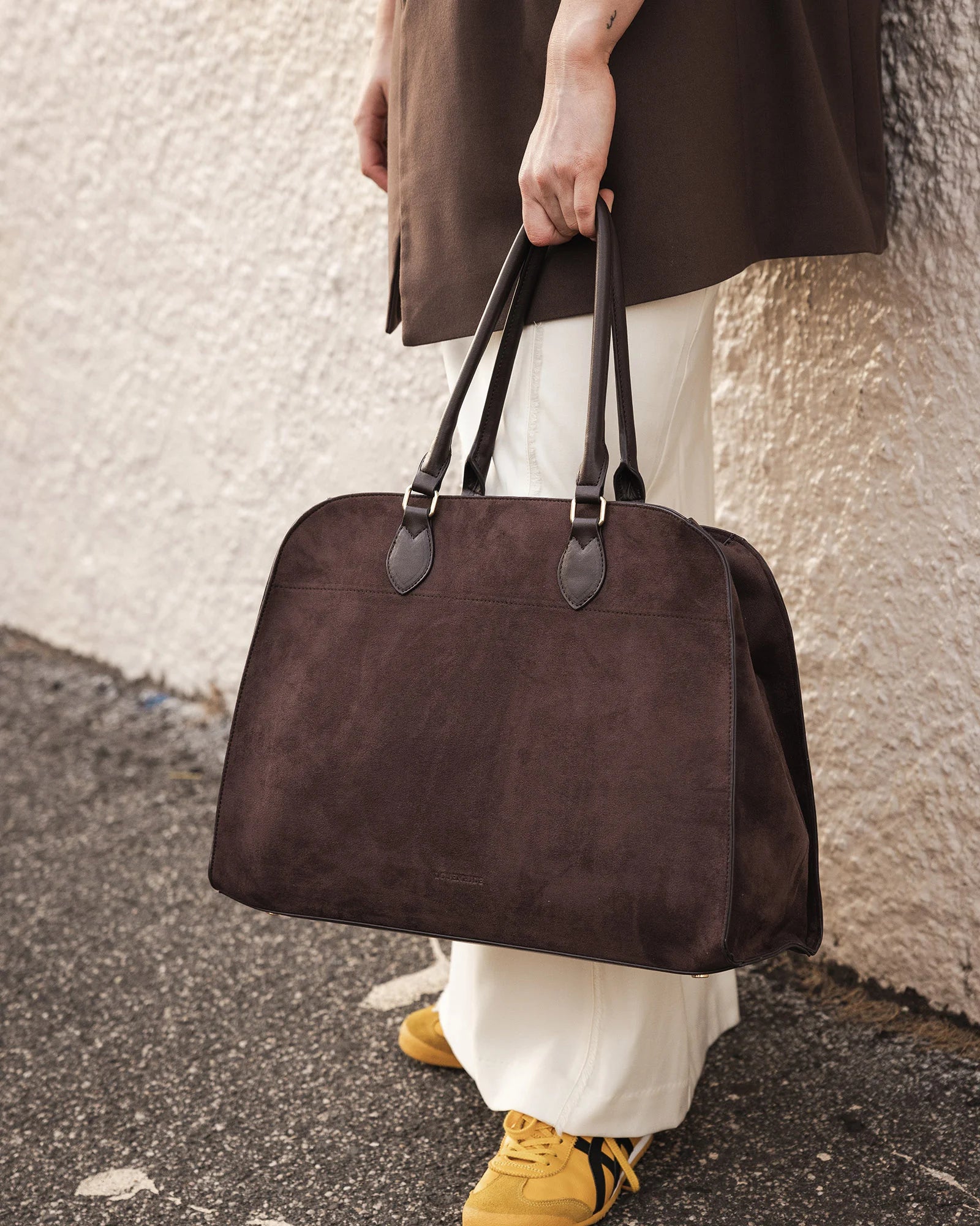 The Louenhide Blaire Tote Bag is the definition of an effortless, statement style. Designed with a bold and unique silhouette, this large tote bag is the perfect throw and go piece with an elevated edge. Designed to have a spacious interior, you can easily fit your daily essentials – and then some. Whether en route to work or heading out for the day, wear it over the shoulder or carry in hand, and let the day unfold. A refined take on an everyday essential, the Blaire Tote Bag blends structure and softness