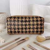 The Louenhide Brianna Makeup Bag is the perfect addition to your beauty routine. Exude style on your next adventure with the visually captivating camel and black houndstooth pattern. Complete with a set of makeup brushes, this women’s small makeup bag is the perfect size for travel.