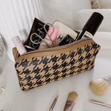 The Louenhide Brianna Makeup Bag is the perfect addition to your beauty routine. Exude style on your next adventure with the visually captivating camel and black houndstooth pattern. Complete with a set of makeup brushes, this women’s small makeup bag is the perfect size for travel.