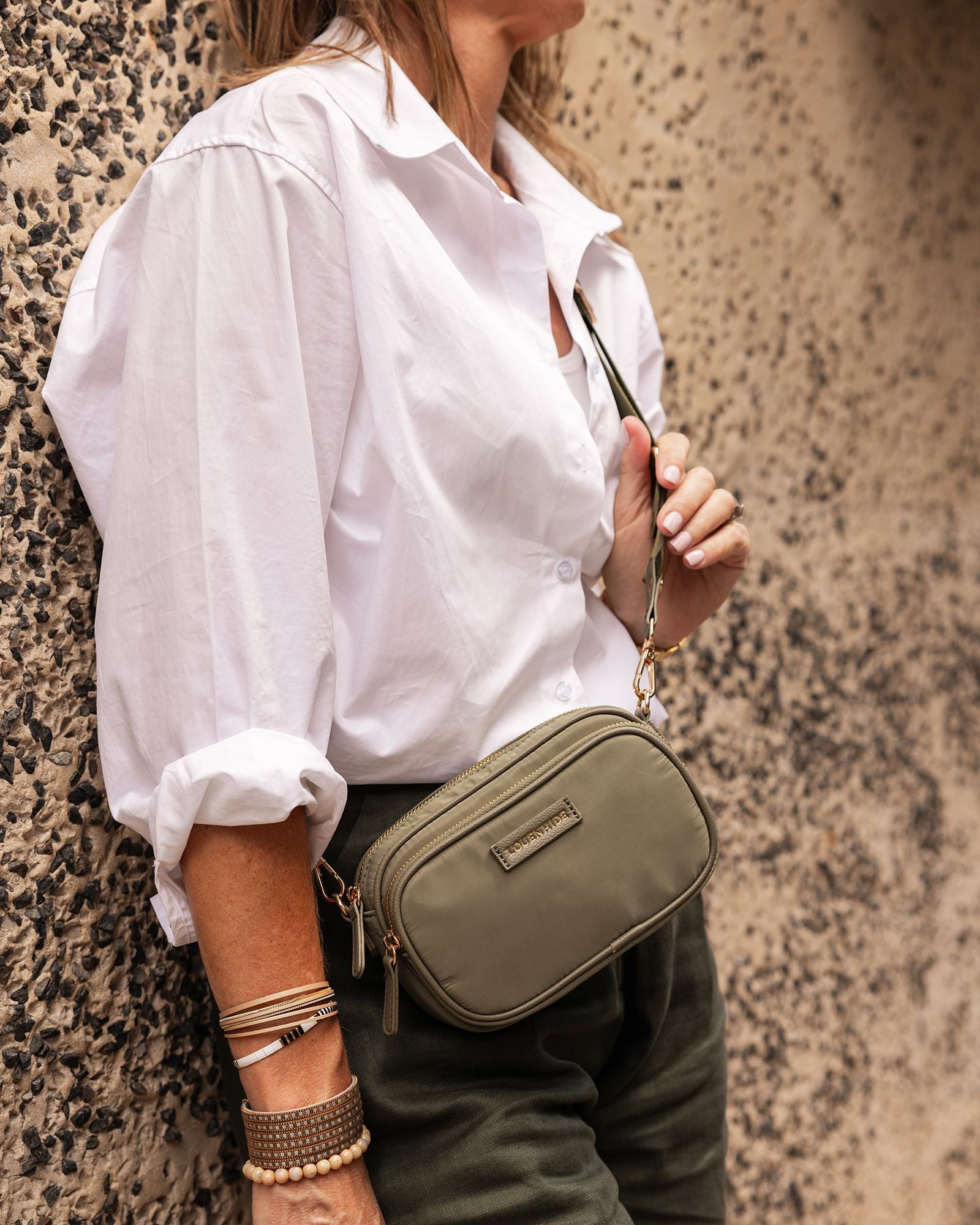 The Louenhide Cali Nylon Crossbody Bag is designed for comfort and convenience. The adjustable and detachable sateen guitar strap allows for comfortable wear crossbody or over the shoulder.