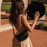 The Louenhide Cassidy Belt Bag is a bold staple designed to add a statement finish to your everyday styling. Crafted in a structured faux leather and adorned with refined hardware accents, this studded bag blends functionality with elevated design. The curved silhouette sits comfortably against the body, while the adjustable strap offers the option to wear it as a classic belt bag or crossbody style - making it one of the best sling bag options for hands-free ease. Compact yet roomy enough for your on-the-g
