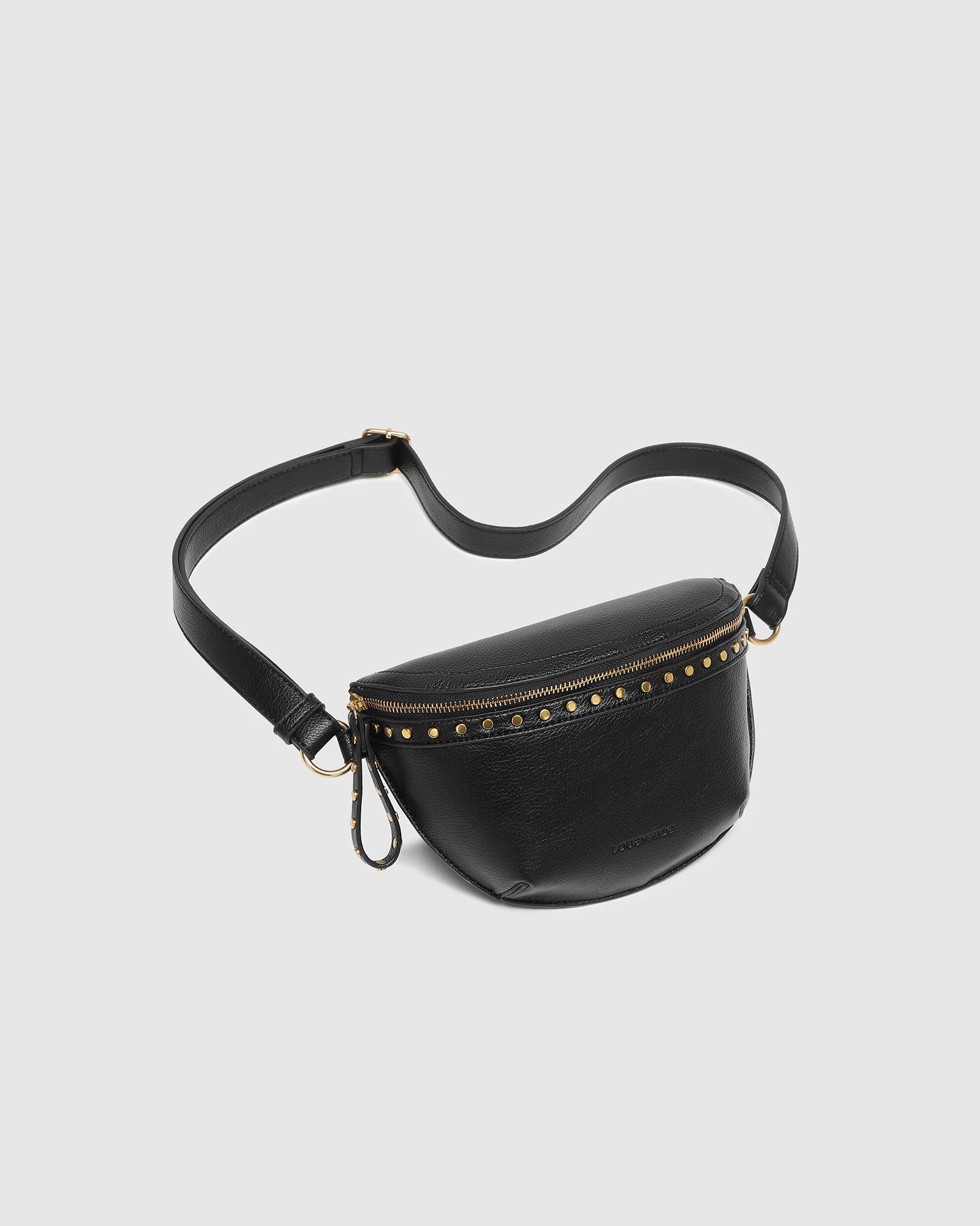 The Louenhide Cassidy Belt Bag is a bold staple designed to add a statement finish to your everyday styling. Crafted in a structured faux leather and adorned with refined hardware accents, this studded bag blends functionality with elevated design. The curved silhouette sits comfortably against the body, while the adjustable strap offers the option to wear it as a classic belt bag or crossbody style - making it one of the best sling bag options for hands-free ease. Compact yet roomy enough for your on-the-g