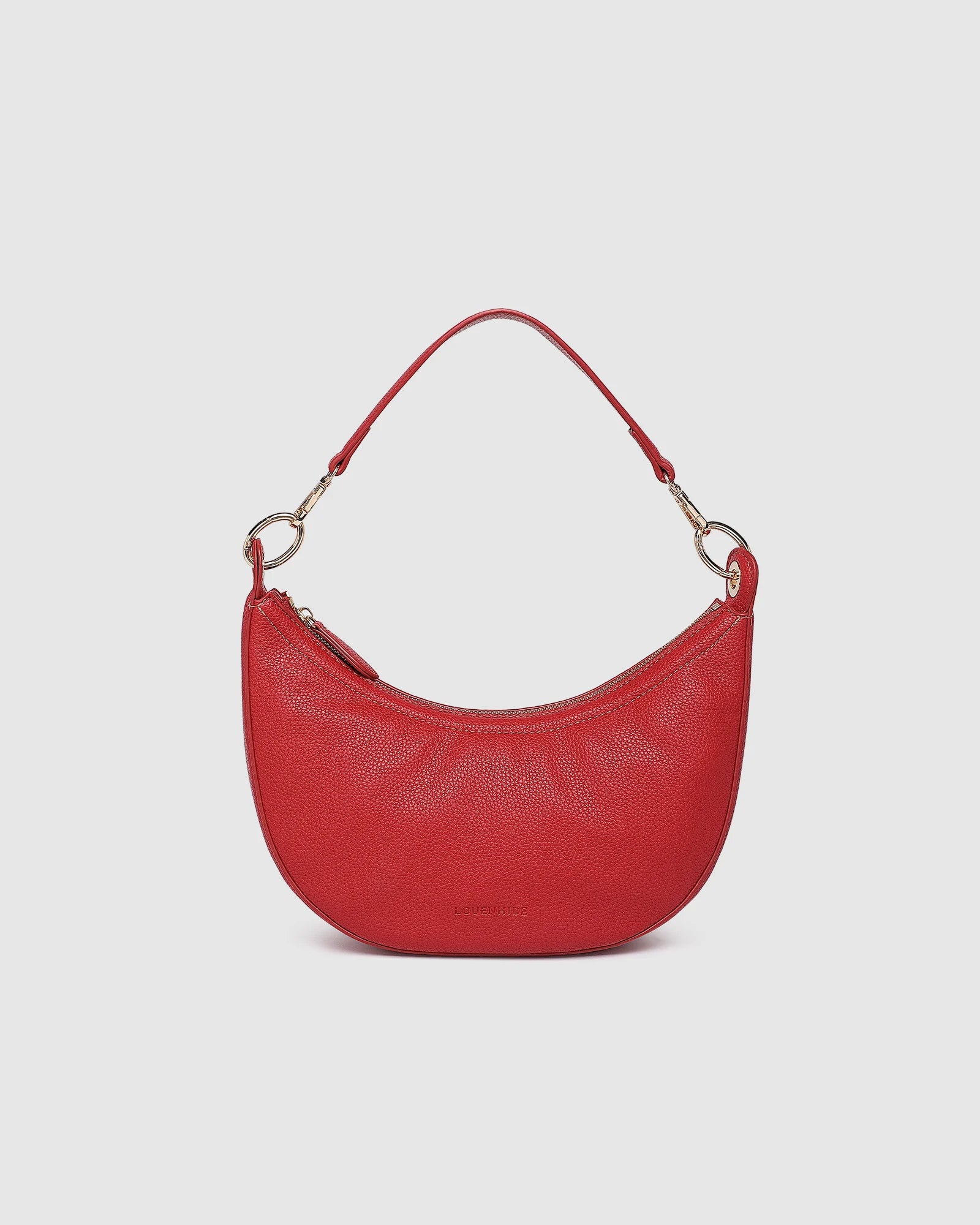 The Louenhide Corfu Handbag is a stunning accessory that combines function and style flawlessly. Perfect for both casual and formal occasions, the stylish crescent moon silhouette will add a touch of elegance and intrigue to your outfit. Accented by contrast feature stitching and light gold hardware, the Corfu is the ideal companion for your vacation wardrobe and pairs beautifully with flowing linens and patterned silks. With multiple ways to wear, style this convertible handbag as an evening bag with the d