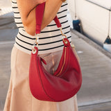 The Louenhide Corfu Handbag is a stunning accessory that combines function and style flawlessly. Perfect for both casual and formal occasions, the stylish crescent moon silhouette will add a touch of elegance and intrigue to your outfit. Accented by contrast feature stitching and light gold hardware, the Corfu is the ideal companion for your vacation wardrobe and pairs beautifully with flowing linens and patterned silks. With multiple ways to wear, style this convertible handbag as an evening bag with the d
