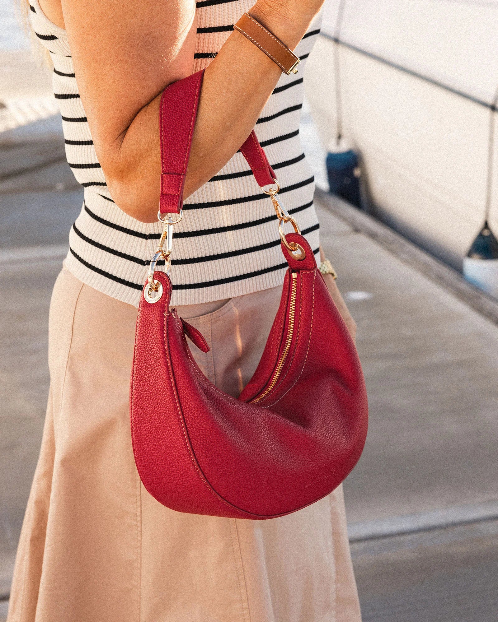 The Louenhide Corfu Handbag is a stunning accessory that combines function and style flawlessly. Perfect for both casual and formal occasions, the stylish crescent moon silhouette will add a touch of elegance and intrigue to your outfit. Accented by contrast feature stitching and light gold hardware, the Corfu is the ideal companion for your vacation wardrobe and pairs beautifully with flowing linens and patterned silks. With multiple ways to wear, style this convertible handbag as an evening bag with the d