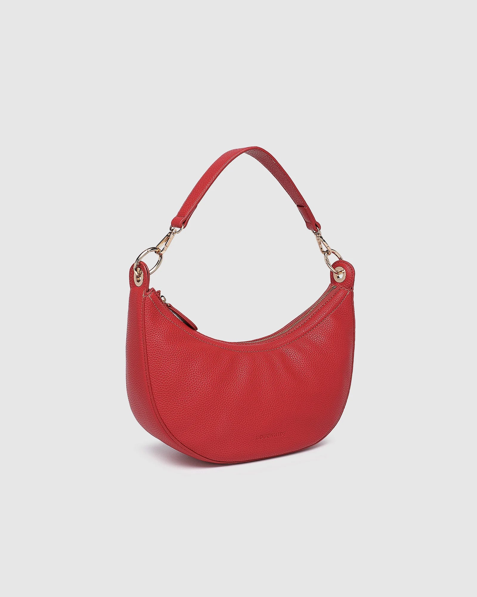 The Louenhide Corfu Handbag is a stunning accessory that combines function and style flawlessly. Perfect for both casual and formal occasions, the stylish crescent moon silhouette will add a touch of elegance and intrigue to your outfit. Accented by contrast feature stitching and light gold hardware, the Corfu is the ideal companion for your vacation wardrobe and pairs beautifully with flowing linens and patterned silks. With multiple ways to wear, style this convertible handbag as an evening bag with the d