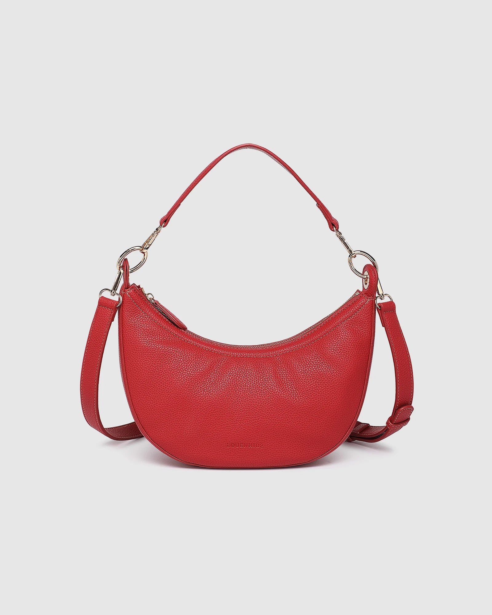 The Louenhide Corfu Handbag is a stunning accessory that combines function and style flawlessly. Perfect for both casual and formal occasions, the stylish crescent moon silhouette will add a touch of elegance and intrigue to your outfit. Accented by contrast feature stitching and light gold hardware, the Corfu is the ideal companion for your vacation wardrobe and pairs beautifully with flowing linens and patterned silks. With multiple ways to wear, style this convertible handbag as an evening bag with the d