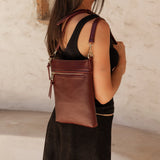 The Louenhide Cressida Crossbody Bag is your go-to for everyday ease and streamlined functionality. Designed in rich, seasonal hues, this crossbody handbag is both timeless and practical. The structured silhouette offers a spacious interior to keep your daily essentials organized, while the secure zip closures ensure everything stays in place. Whether worn over the shoulder or across the body, the adjustable strap lets you tailor the fit to suit your day. With subtle design detailing and a sleek shape, this