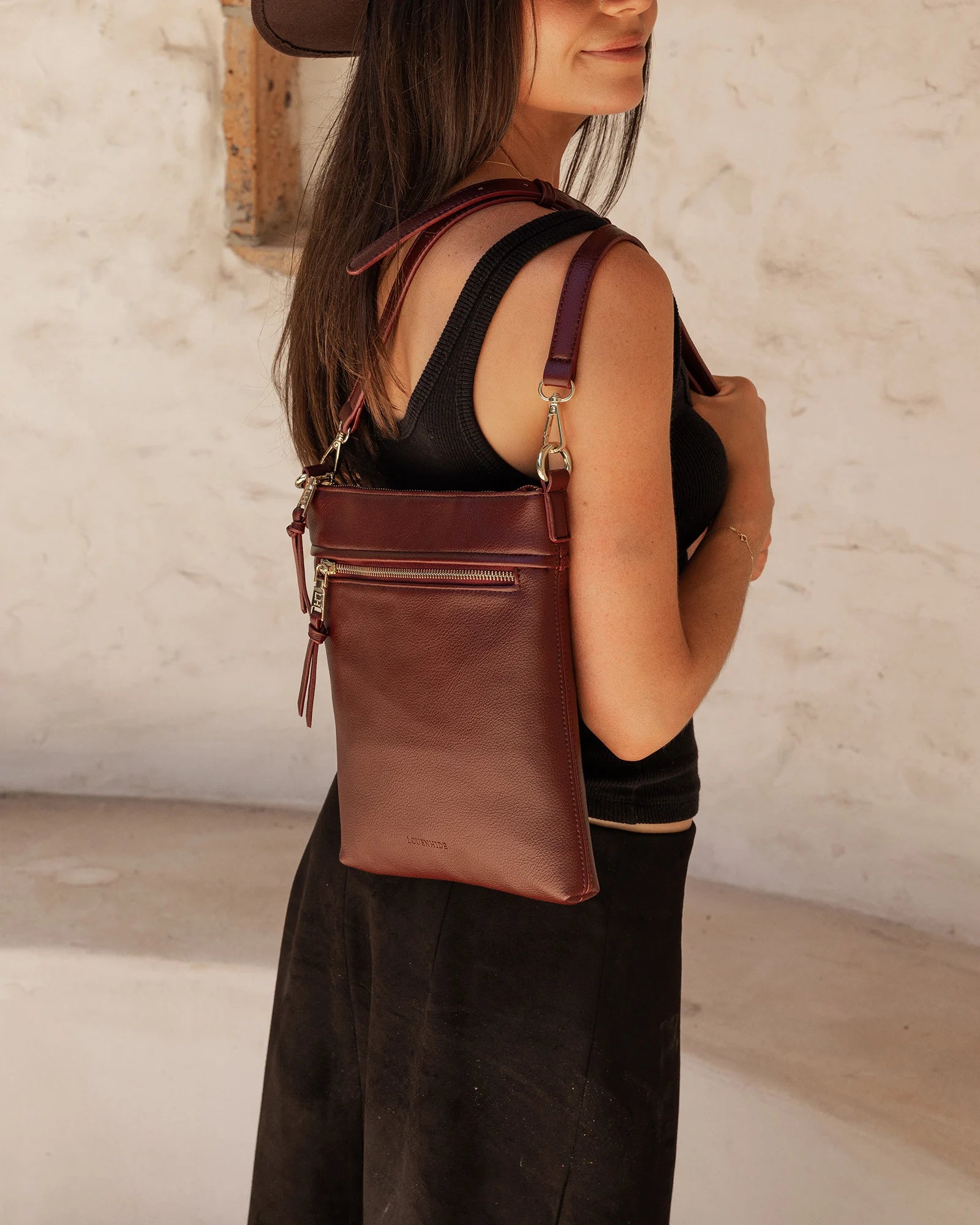 The Louenhide Cressida Crossbody Bag is your go-to for everyday ease and streamlined functionality. Designed in rich, seasonal hues, this crossbody handbag is both timeless and practical. The structured silhouette offers a spacious interior to keep your daily essentials organized, while the secure zip closures ensure everything stays in place. Whether worn over the shoulder or across the body, the adjustable strap lets you tailor the fit to suit your day. With subtle design detailing and a sleek shape, this