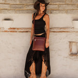 The Louenhide Cressida Crossbody Bag is your go-to for everyday ease and streamlined functionality. Designed in rich, seasonal hues, this crossbody handbag is both timeless and practical. The structured silhouette offers a spacious interior to keep your daily essentials organized, while the secure zip closures ensure everything stays in place. Whether worn over the shoulder or across the body, the adjustable strap lets you tailor the fit to suit your day. With subtle design detailing and a sleek shape, this