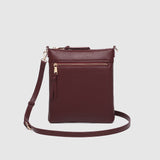The Louenhide Cressida Crossbody Bag is your go-to for everyday ease and streamlined functionality. Designed in rich, seasonal hues, this crossbody handbag is both timeless and practical. The structured silhouette offers a spacious interior to keep your daily essentials organized, while the secure zip closures ensure everything stays in place. Whether worn over the shoulder or across the body, the adjustable strap lets you tailor the fit to suit your day. With subtle design detailing and a sleek shape, this
