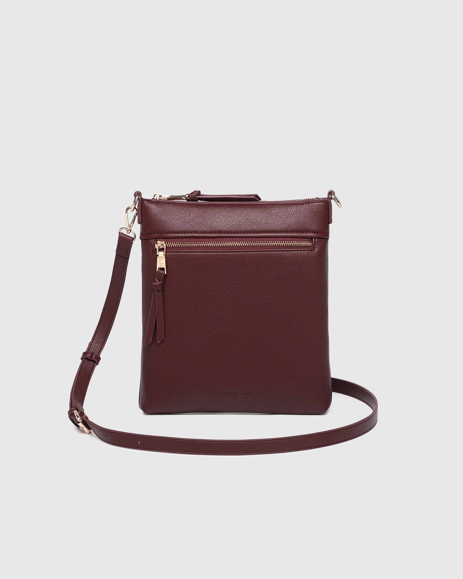The Louenhide Cressida Crossbody Bag is your go-to for everyday ease and streamlined functionality. Designed in rich, seasonal hues, this crossbody handbag is both timeless and practical. The structured silhouette offers a spacious interior to keep your daily essentials organized, while the secure zip closures ensure everything stays in place. Whether worn over the shoulder or across the body, the adjustable strap lets you tailor the fit to suit your day. With subtle design detailing and a sleek shape, this