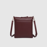 The Louenhide Cressida Crossbody Bag is your go-to for everyday ease and streamlined functionality. Designed in rich, seasonal hues, this crossbody handbag is both timeless and practical. The structured silhouette offers a spacious interior to keep your daily essentials organized, while the secure zip closures ensure everything stays in place. Whether worn over the shoulder or across the body, the adjustable strap lets you tailor the fit to suit your day. With subtle design detailing and a sleek shape, this