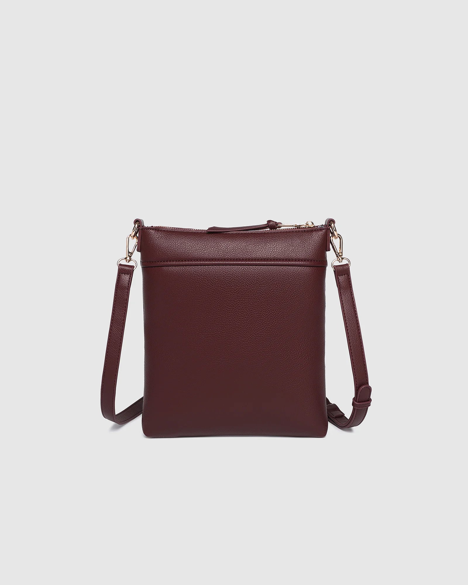The Louenhide Cressida Crossbody Bag is your go-to for everyday ease and streamlined functionality. Designed in rich, seasonal hues, this crossbody handbag is both timeless and practical. The structured silhouette offers a spacious interior to keep your daily essentials organized, while the secure zip closures ensure everything stays in place. Whether worn over the shoulder or across the body, the adjustable strap lets you tailor the fit to suit your day. With subtle design detailing and a sleek shape, this