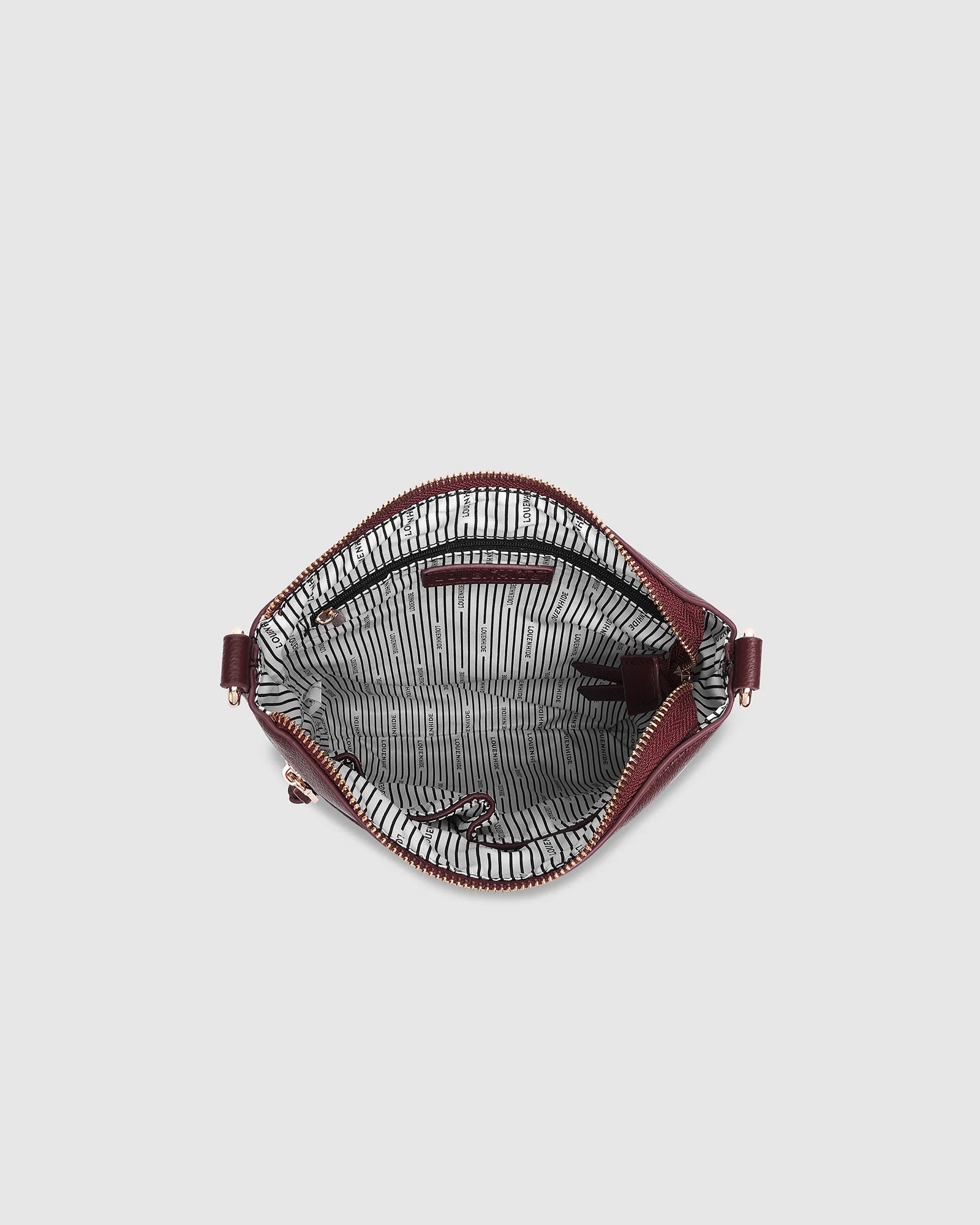 The Louenhide Cressida Crossbody Bag is your go-to for everyday ease and streamlined functionality. Designed in rich, seasonal hues, this crossbody handbag is both timeless and practical. The structured silhouette offers a spacious interior to keep your daily essentials organized, while the secure zip closures ensure everything stays in place. Whether worn over the shoulder or across the body, the adjustable strap lets you tailor the fit to suit your day. With subtle design detailing and a sleek shape, this