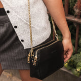 The Louenhide Elle Crossbody Bag is the elevated staple your wardrobe has been waiting for. Designed with a compact rectangular silhouette, this triple compartment crossbody bag keeps your essentials streamlined and organized without compromising style. To switch up your look with ease, opt for the gold chain strap to elevate your dressier on-the-go moments or swap to the matching faux leather strap for an casual feel. Adorned with light gold hardware, this multi-zipper crossbody bag is designed to carry