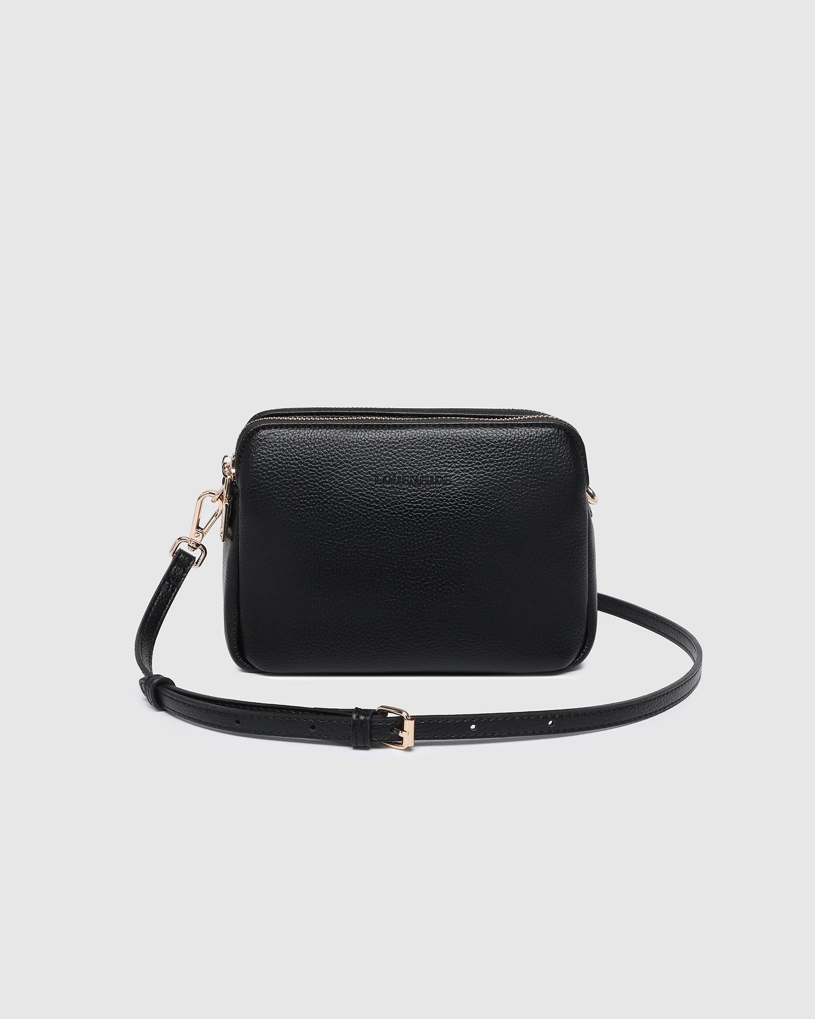 The Louenhide Elle Crossbody Bag is the elevated staple your wardrobe has been waiting for. Designed with a compact rectangular silhouette, this triple compartment crossbody bag keeps your essentials streamlined and organized without compromising style. To switch up your look with ease, opt for the gold chain strap to elevate your dressier on-the-go moments or swap to the matching faux leather strap for an casual feel. Adorned with light gold hardware, this multi-zipper crossbody bag is designed to carry