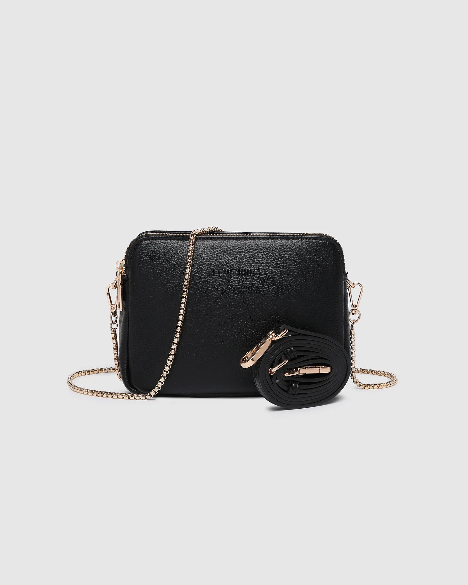 The Louenhide Elle Crossbody Bag is the elevated staple your wardrobe has been waiting for. Designed with a compact rectangular silhouette, this triple compartment crossbody bag keeps your essentials streamlined and organized without compromising style. To switch up your look with ease, opt for the gold chain strap to elevate your dressier on-the-go moments or swap to the matching faux leather strap for an casual feel. Adorned with light gold hardware, this multi-zipper crossbody bag is designed to carry