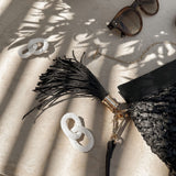 The Louenhide Fern Raffia Crossbody is the ultimate accessory for your summer getaway. Doubling as a crossbody or clutch, it embodies the essence of sun-soaked adventures and chic style.