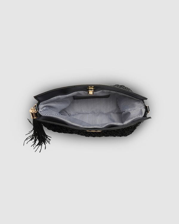 The Louenhide Fern Raffia Crossbody is the ultimate accessory for your summer getaway. Doubling as a crossbody or clutch, it embodies the essence of sun-soaked adventures and chic style.