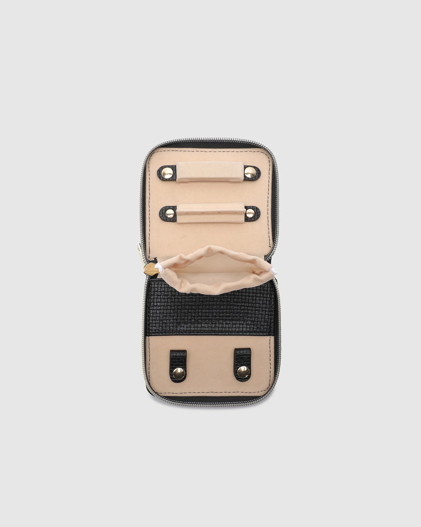 The Louenhide Juniper Jewelry Case is ideal for those who appreciate the finer details in their jewelry storage. Designed with your dynamic lifestyle in mind, this jewellery wallet is compact and portable. Whether placed on your vanity at home or tucked into your luggage for travel, the Juniper ensures your favourite pieces are protected wherever you go. Organize your pieces with the two press stud hooks, slip pocket, drawstring bag, ring roll and earring press stud band. Structured and protected, th