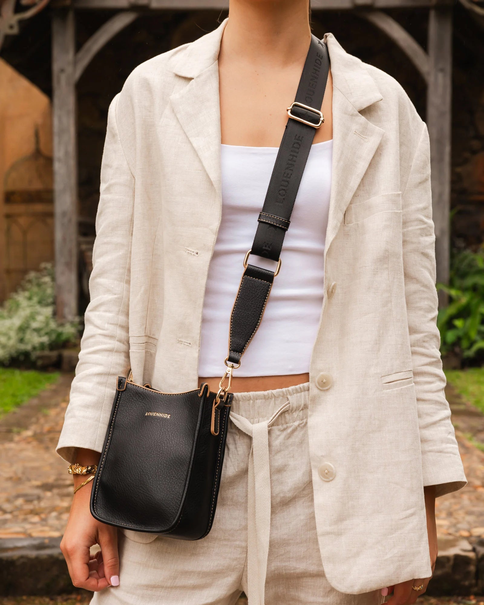 The Louenhide Parker Phone Crossbody Bag effortlessly combines an elevated aesthetic with everyday functionality. Whether you're heading to the office, running errands or meeting friends for coffee, this minimalistic phone bag will be your new go-to. Parker features an on-trend and modern silhouette, enhanced by the contrasting stitch details in two classic colourways. Elevate your style with the sateen webbing guitar strap or keep it simple with the matching vegan leather crossbody strap. Keeping your esse