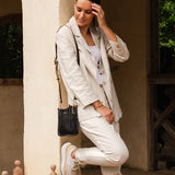 The Louenhide Parker Phone Crossbody Bag effortlessly combines an elevated aesthetic with everyday functionality. Whether you're heading to the office, running errands or meeting friends for coffee, this minimalistic phone bag will be your new go-to. Parker features an on-trend and modern silhouette, enhanced by the contrasting stitch details in two classic colourways. Elevate your style with the sateen webbing guitar strap or keep it simple with the matching vegan leather crossbody strap. Keeping your esse
