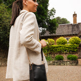 The Louenhide Parker Phone Crossbody Bag effortlessly combines an elevated aesthetic with everyday functionality. Whether you're heading to the office, running errands or meeting friends for coffee, this minimalistic phone bag will be your new go-to. Parker features an on-trend and modern silhouette, enhanced by the contrasting stitch details in two classic colourways. Elevate your style with the sateen webbing guitar strap or keep it simple with the matching vegan leather crossbody strap. Keeping your esse