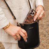 The Louenhide Parker Phone Crossbody Bag effortlessly combines an elevated aesthetic with everyday functionality. Whether you're heading to the office, running errands or meeting friends for coffee, this minimalistic phone bag will be your new go-to. Parker features an on-trend and modern silhouette, enhanced by the contrasting stitch details in two classic colourways. Elevate your style with the sateen webbing guitar strap or keep it simple with the matching vegan leather crossbody strap. Keeping your esse