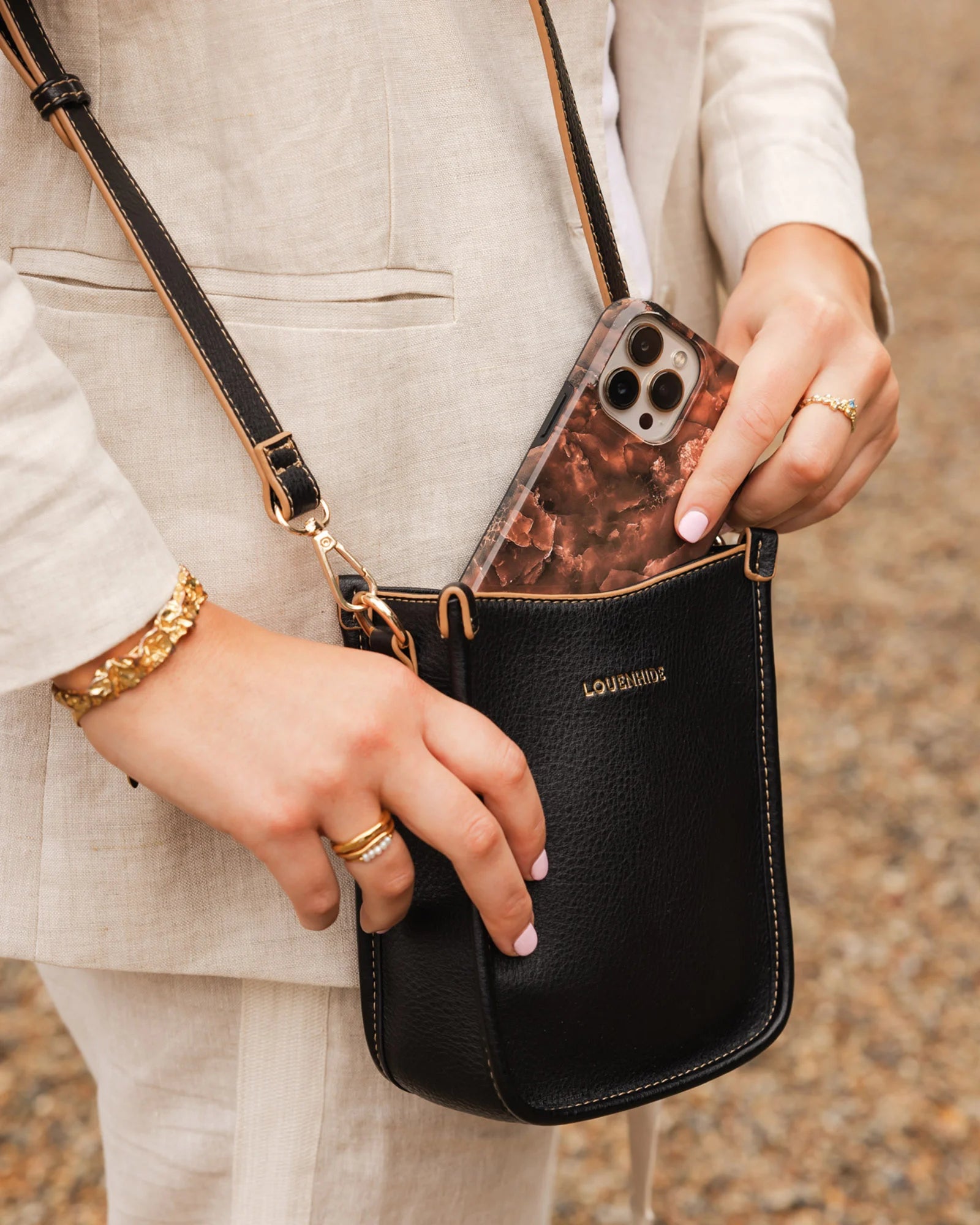 The Louenhide Parker Phone Crossbody Bag effortlessly combines an elevated aesthetic with everyday functionality. Whether you're heading to the office, running errands or meeting friends for coffee, this minimalistic phone bag will be your new go-to. Parker features an on-trend and modern silhouette, enhanced by the contrasting stitch details in two classic colourways. Elevate your style with the sateen webbing guitar strap or keep it simple with the matching vegan leather crossbody strap. Keeping your esse