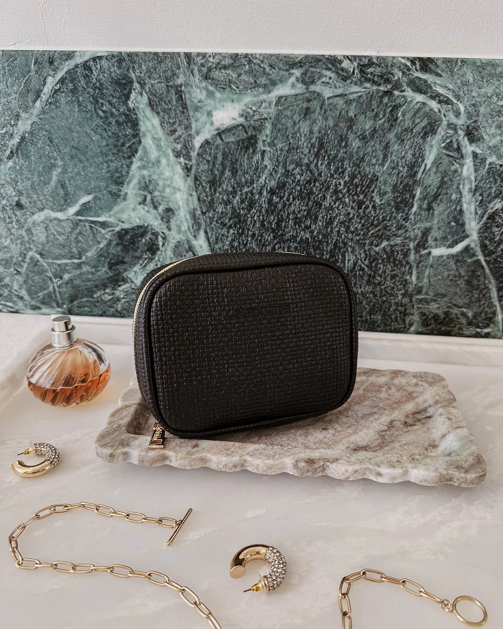 The Louenhide Rita Jewelry Case is the ideal travel accessory you didn't know you needed. Perfectly sized for travel, this women's jewellery case is a must-have for keeping your jewellery organized and protected on the go. Its sleek design fits effortlessly into your luggage or carry-on, while ensuring your accessories are always secure, organised and ready to shine. Say goodbye to tangled necklaces and lost earrings. With the ultimate internal organisation, there's a spot for everything. Whether you're jet