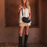 The Louenhide Saylor Crossbody Bag brings a bold yet refined edge to your everyday styling in a soft vegan leather finish. A sleek baguette-shaped silhouette, this cross body bag with chain detailing blends texture and refinement in all the right ways. Designed to be worn with ease but styled to stand out, the Saylor Black moves effortlessly from day to night, adding impact to your layered winter looks. Wherever the day leads, this chain strap handbag is the finishing touch that completes the look.
