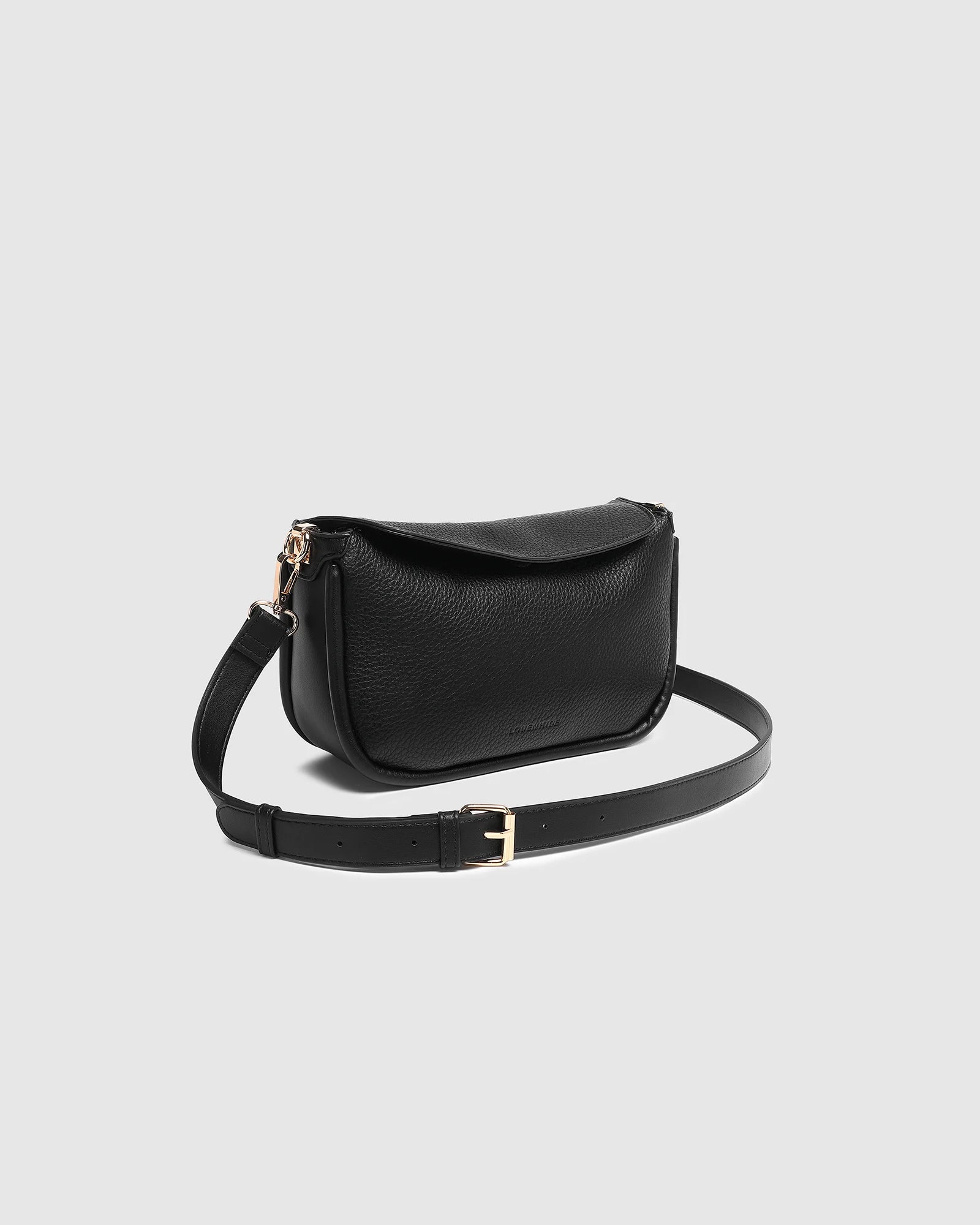 The Louenhide Saylor Crossbody Bag brings a bold yet refined edge to your everyday styling in a soft vegan leather finish. A sleek baguette-shaped silhouette, this cross body bag with chain detailing blends texture and refinement in all the right ways. Designed to be worn with ease but styled to stand out, the Saylor Black moves effortlessly from day to night, adding impact to your layered winter looks. Wherever the day leads, this chain strap handbag is the finishing touch that completes the look.