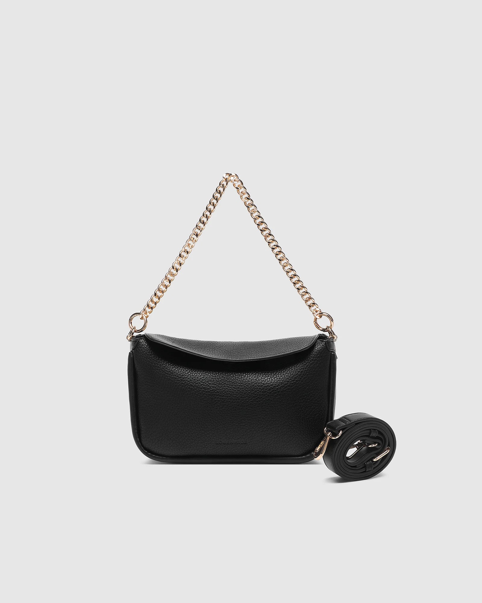 The Louenhide Saylor Crossbody Bag brings a bold yet refined edge to your everyday styling in a soft vegan leather finish. A sleek baguette-shaped silhouette, this cross body bag with chain detailing blends texture and refinement in all the right ways. Designed to be worn with ease but styled to stand out, the Saylor Black moves effortlessly from day to night, adding impact to your layered winter looks. Wherever the day leads, this chain strap handbag is the finishing touch that completes the look.