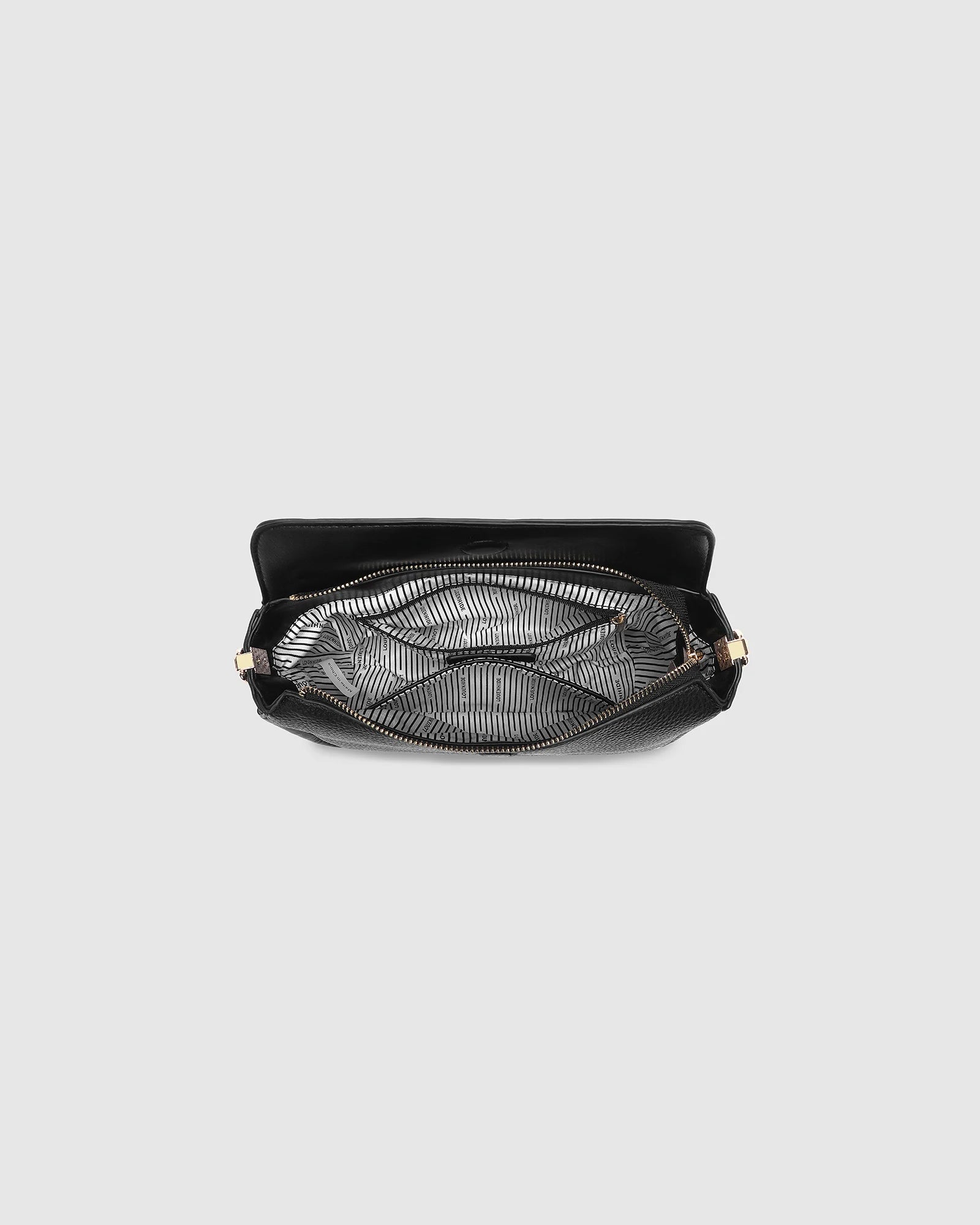 The Louenhide Saylor Crossbody Bag brings a bold yet refined edge to your everyday styling in a soft vegan leather finish. A sleek baguette-shaped silhouette, this cross body bag with chain detailing blends texture and refinement in all the right ways. Designed to be worn with ease but styled to stand out, the Saylor Black moves effortlessly from day to night, adding impact to your layered winter looks. Wherever the day leads, this chain strap handbag is the finishing touch that completes the look.