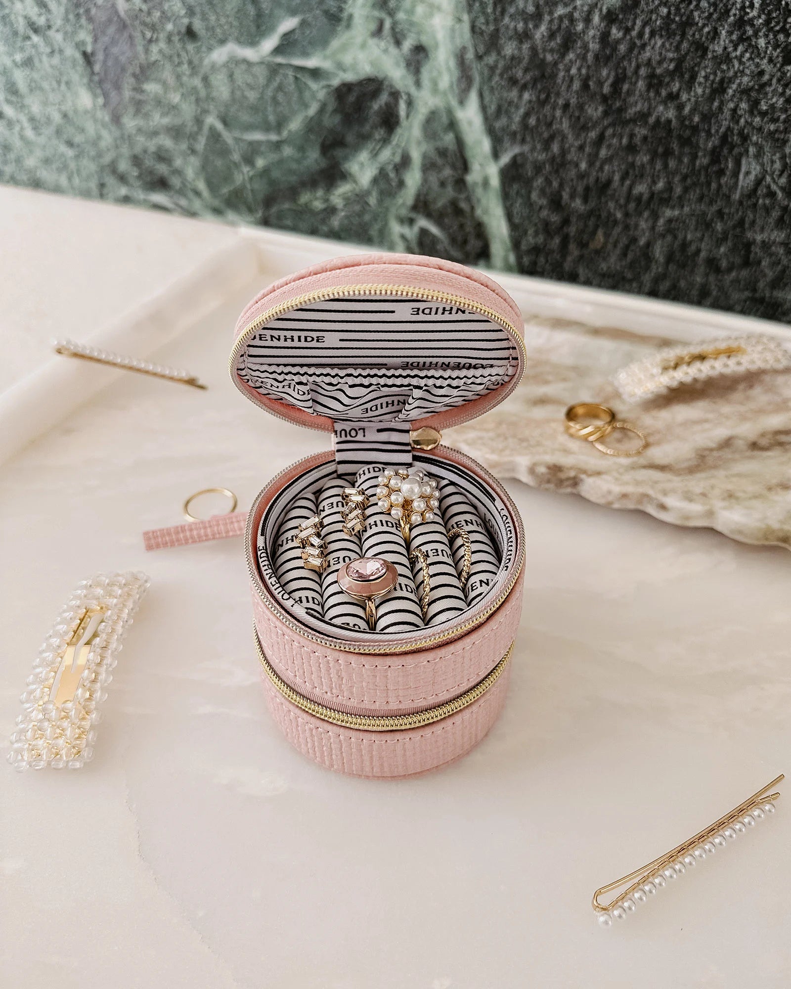 The Louenhide Sofia Jewelry Box is designed to hold and protect your most treasured pieces. Featuring a compact silhouette with two protective compartments, this multi-zipper case offers a streamlined way to store your jewellery without taking up unnecessary space. This travel jewellery case is the perfect addition to your bag, ensuring valuables stay secure and organised wherever the day leads.