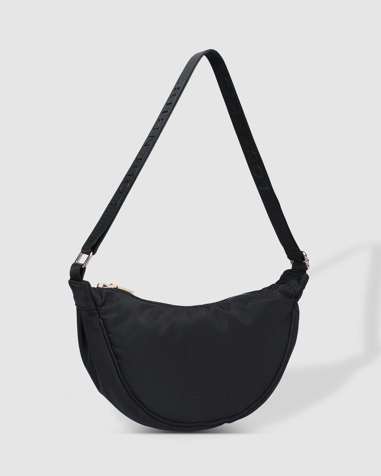 The Louenhide Sylvia Nylon Crossbody Bag is an on-trend style, featuring a modern crescent silhouette.