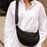 The Louenhide Sylvia Nylon Crossbody Bag is an on-trend style, featuring a modern crescent silhouette.